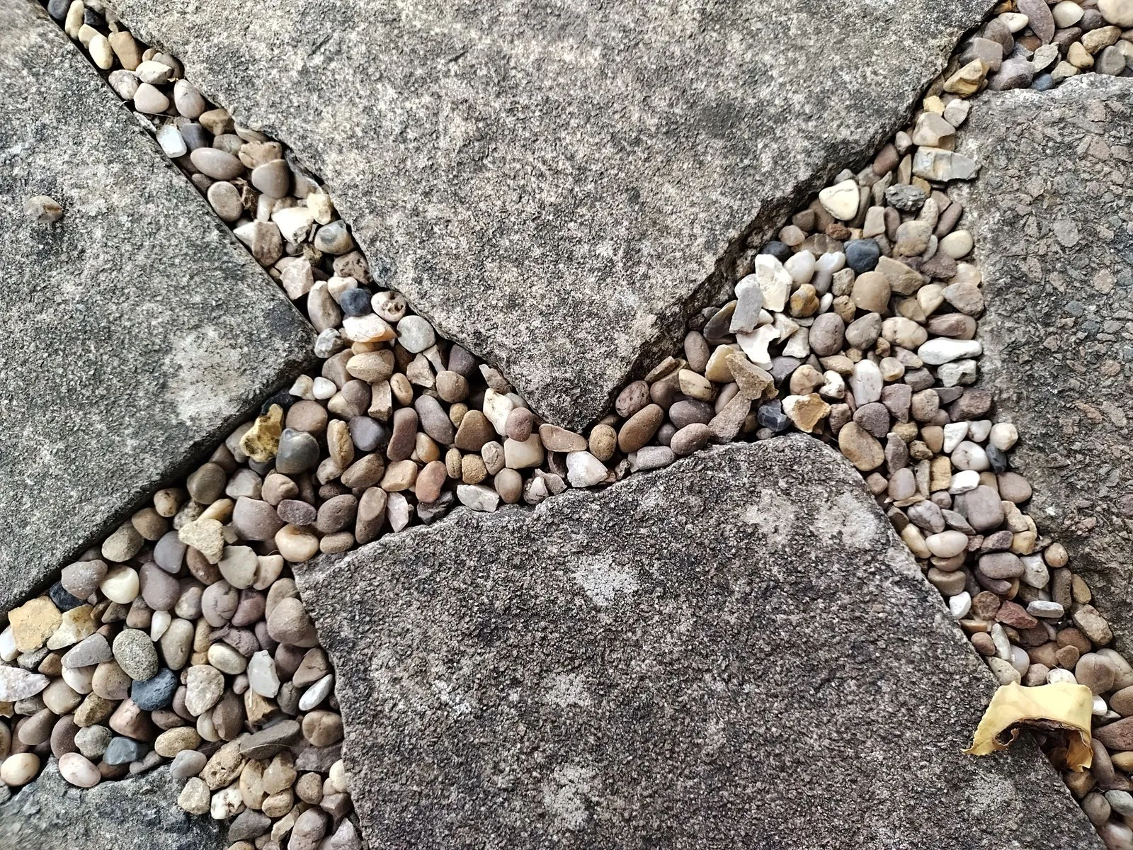 Close-up of stone pavement and pebbles forming a textured pattern.